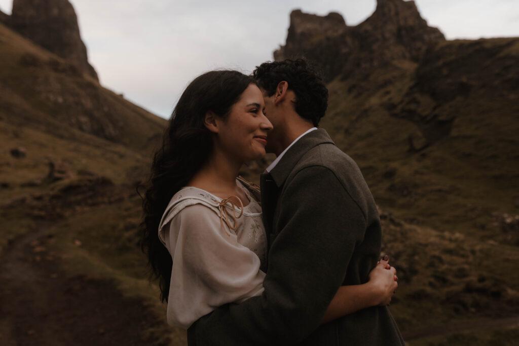 Romantic portrait of a couple embracing during an Isle of Skye couples photoshoot, captured in a fine art, editorial style by Aly Robinson Photography.