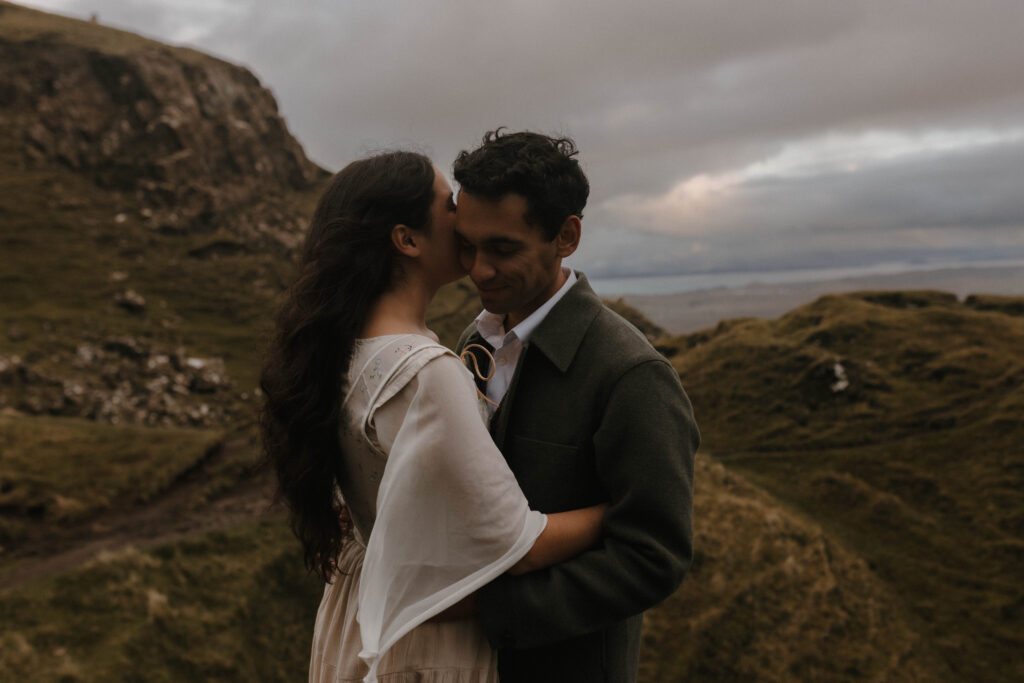 Romantic portrait of a couple embracing during an Isle of Skye couples photoshoot, captured in cinematic, fine art style on the Quiraing by Aly Robinson Photography.