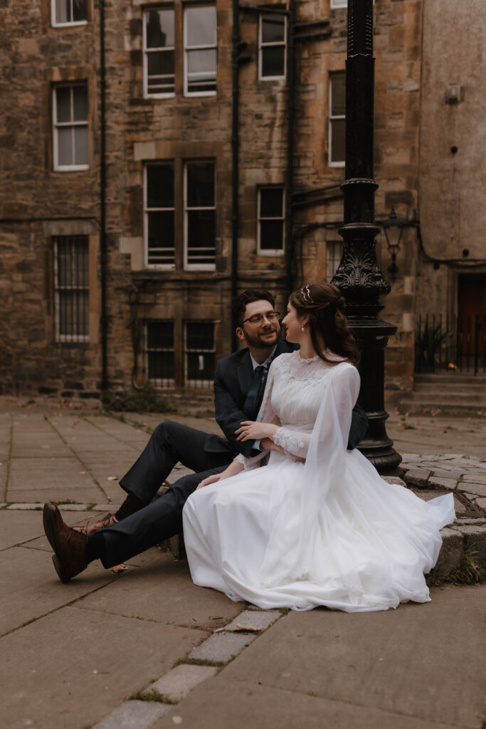 American couple cinematic engagement portrait Old Town Edinburgh
