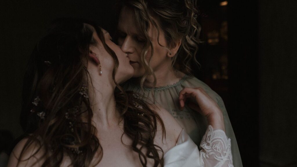 GBTQ+ couple kissing during their Glencoe elopement, captured in a cinematic fine art style by Aly Robinson Photography, Scotland LGBTQ+ wedding photographer.