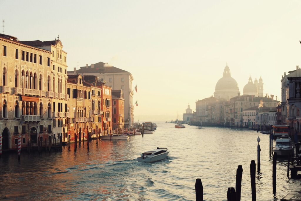 Luxury destination wedding photography in Scotland and Italy, featuring a romantic European canal scene at golden hour
