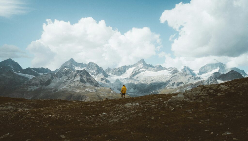 A photographer looking through a camera in an interesting landscape.