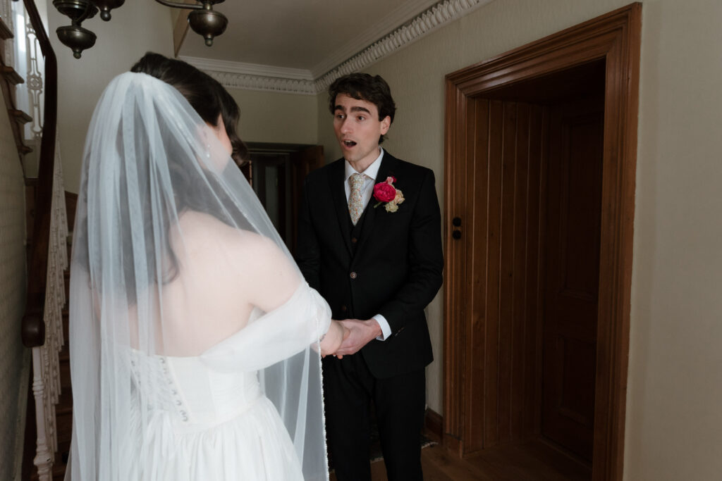 Private first look at Dalduff Farm wedding near Glasgow with the groom seeing the bride before the ceremony