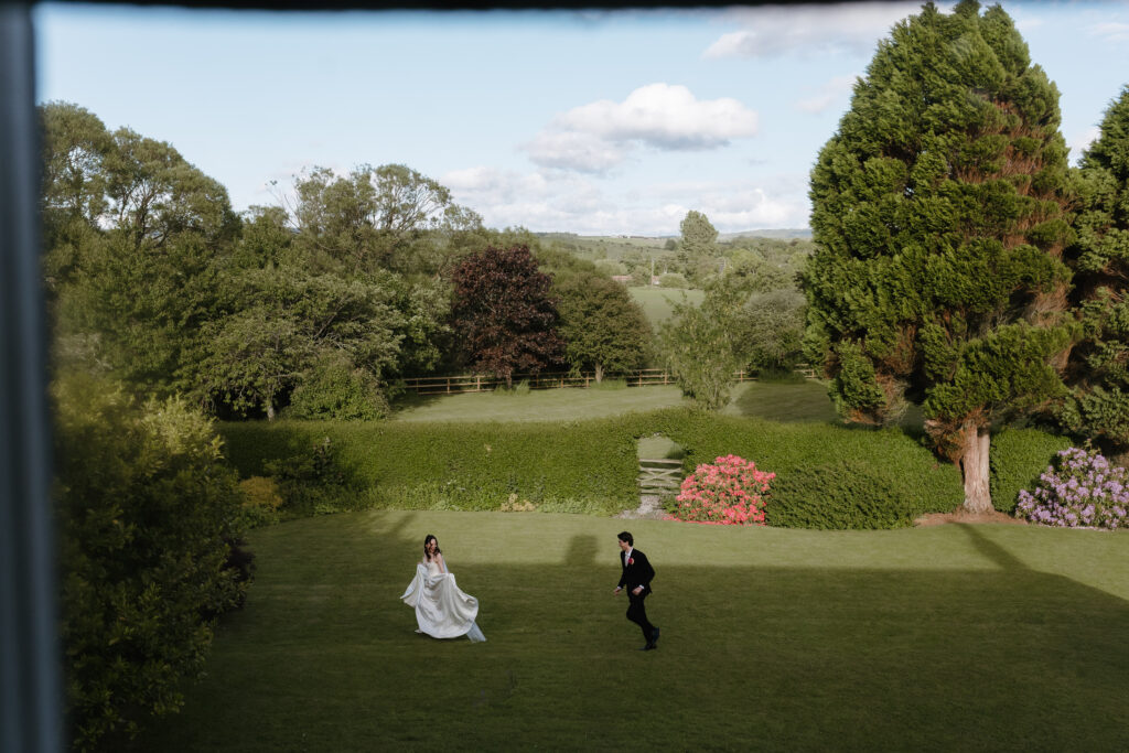 Dalduff Farm wedding photographer capturing a bride and groom running through the gardens during a summer wedding near Glasgow