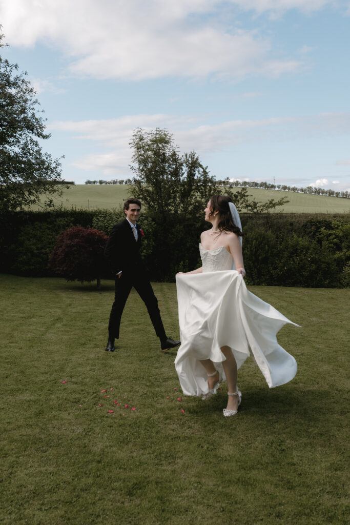 Cinematic wedding photography at Dalduff Farm near Glasgow with a bride and groom walking together outdoors